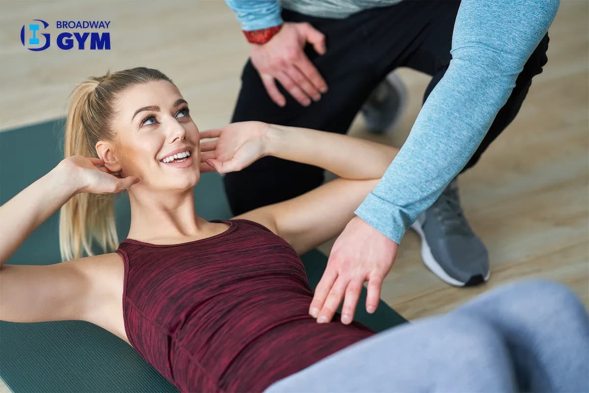 Personal trainer instructing a woman