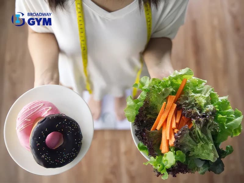 Girl holding vegetable salad and donuts
