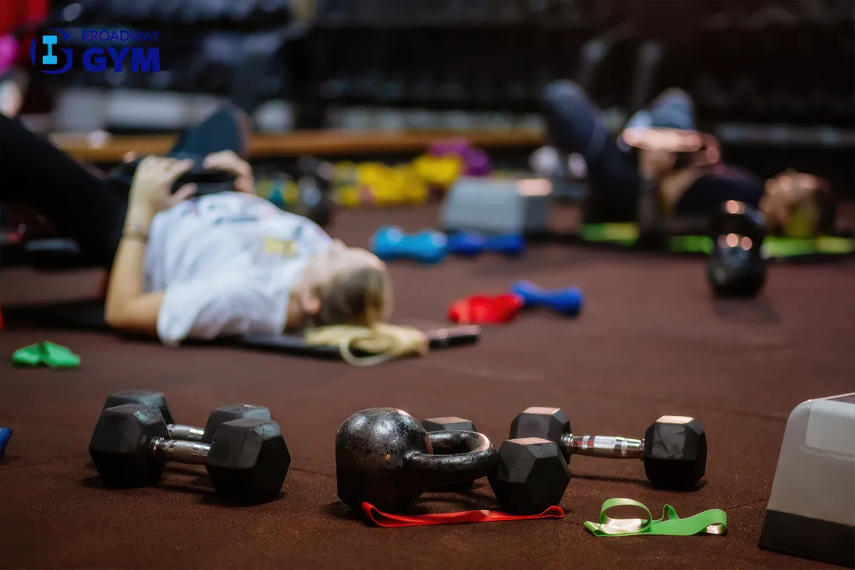 Dumbbells on the floor and women exercising on the floor